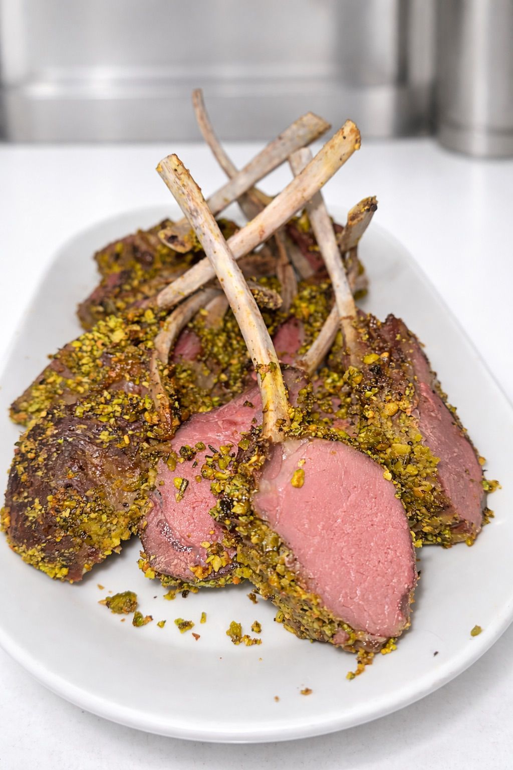 Pistachio-crusted rack of lamb, sliced to reveal pink center
